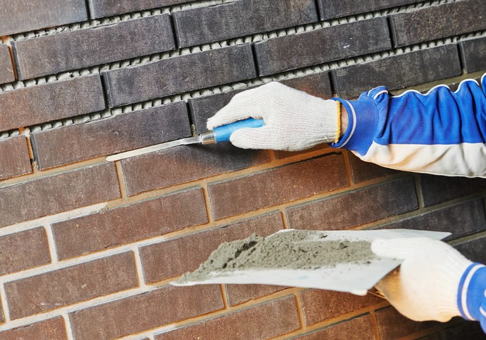 39stock-photo-bricklaying-using-the-brick-jointer-trowel-693240019